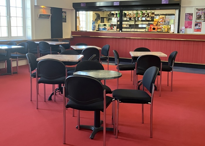 The Manor Pavilion bar with red carpet and chairs