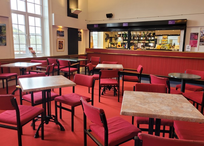 The Manor Pavilion bar with red carpet and chairs