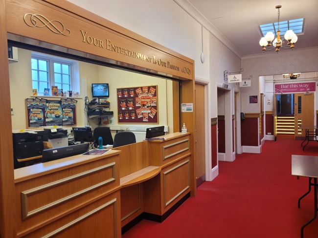 The box office with red carpet and wood